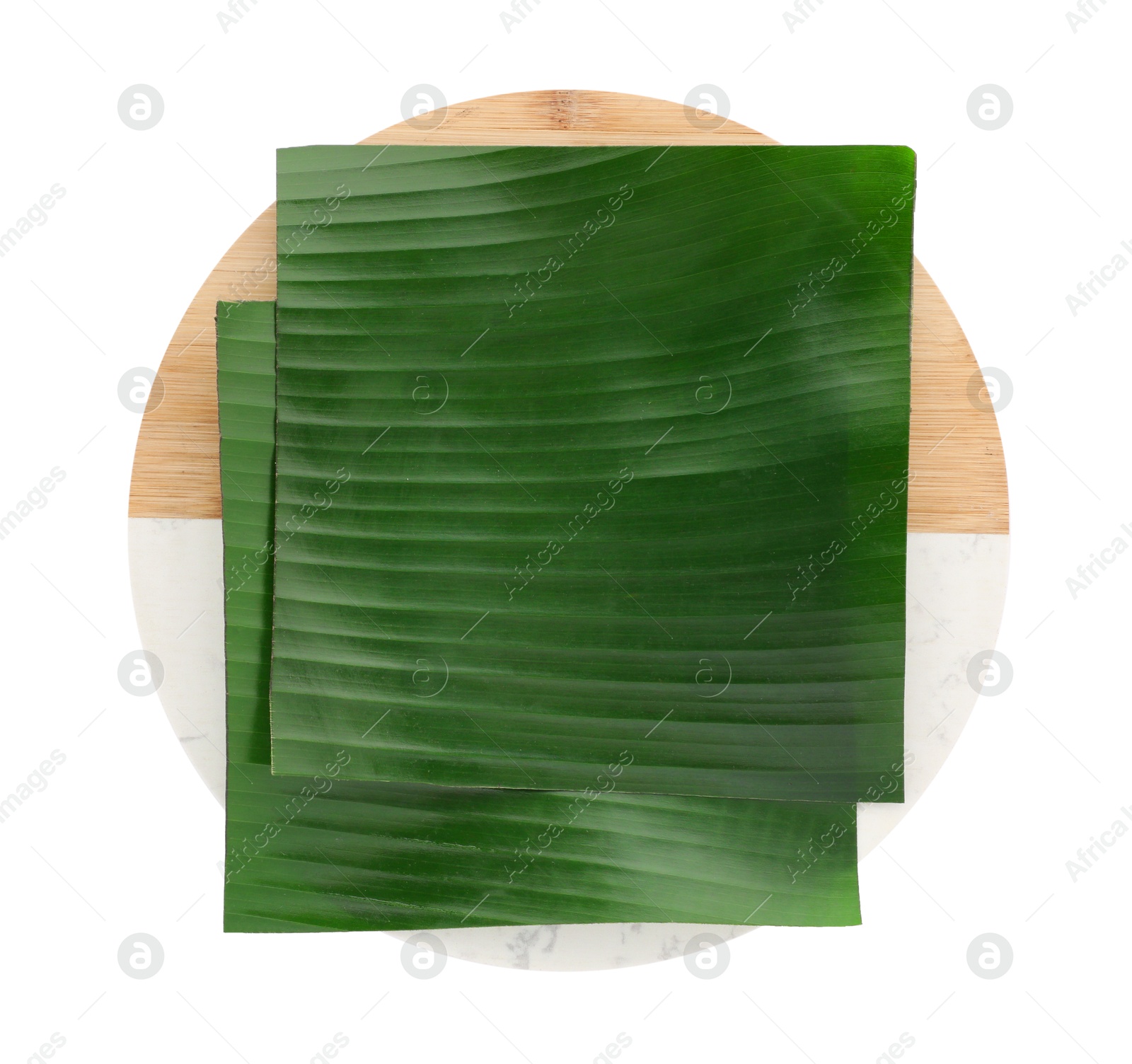 Photo of Pieces of banana leaves isolated on white, top view. Traditional meal serving