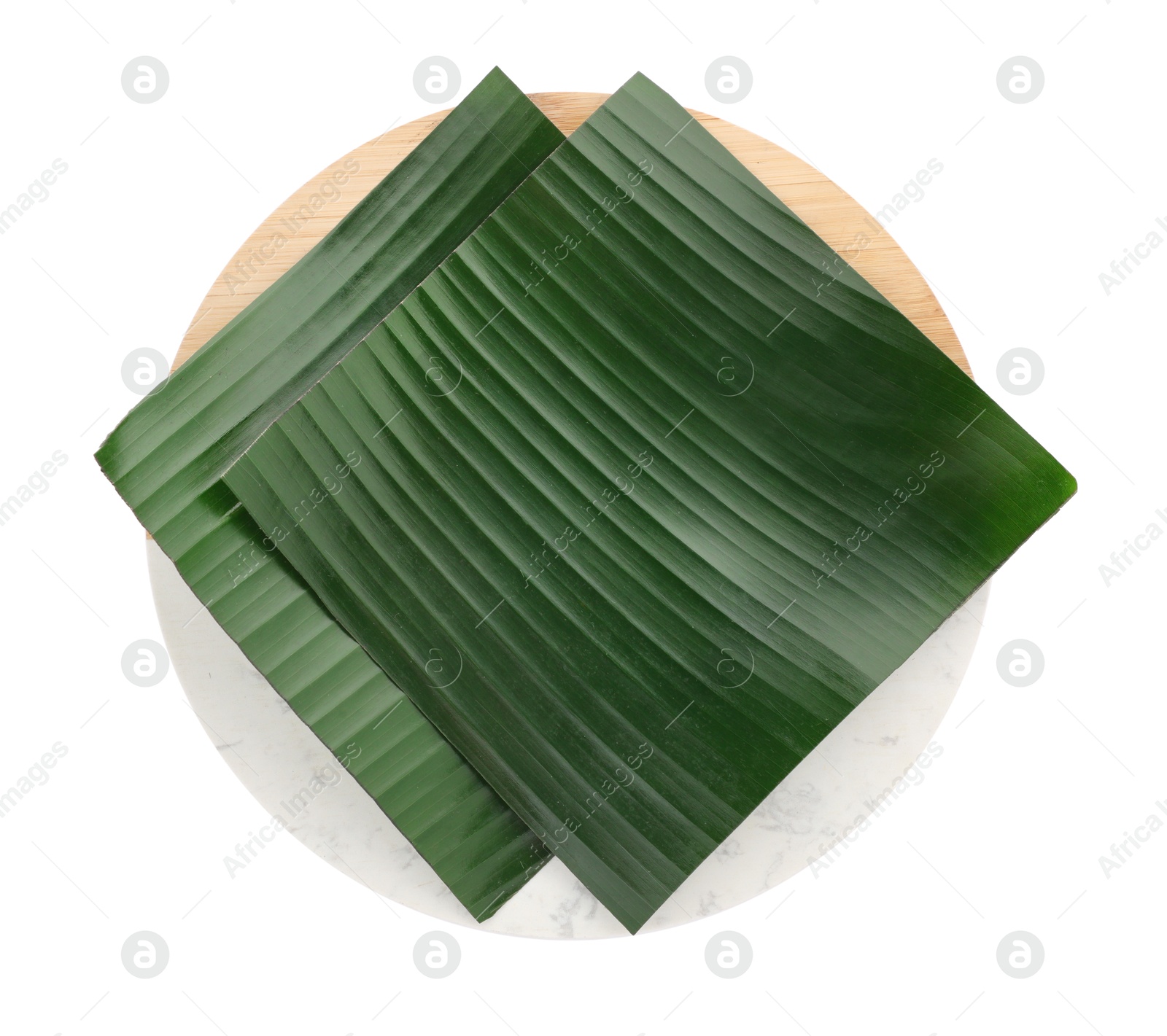 Photo of Pieces of banana leaves isolated on white, top view. Traditional meal serving