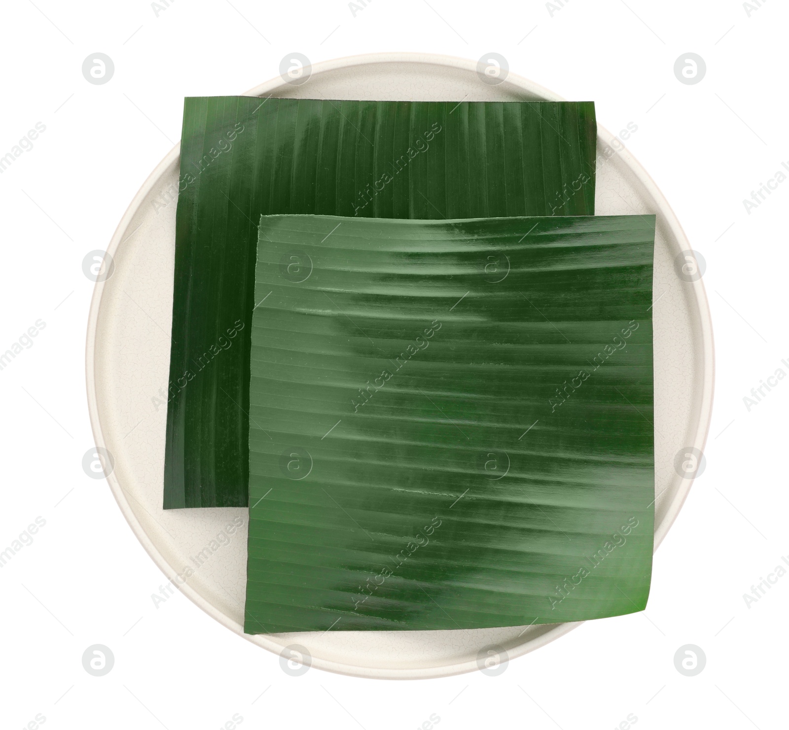 Photo of Pieces of banana leaves isolated on white, top view. Traditional meal serving