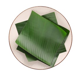 Photo of Pieces of banana leaves isolated on white, top view. Traditional meal serving