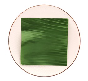 Photo of Pieces of banana leaves isolated on white, top view. Traditional meal serving