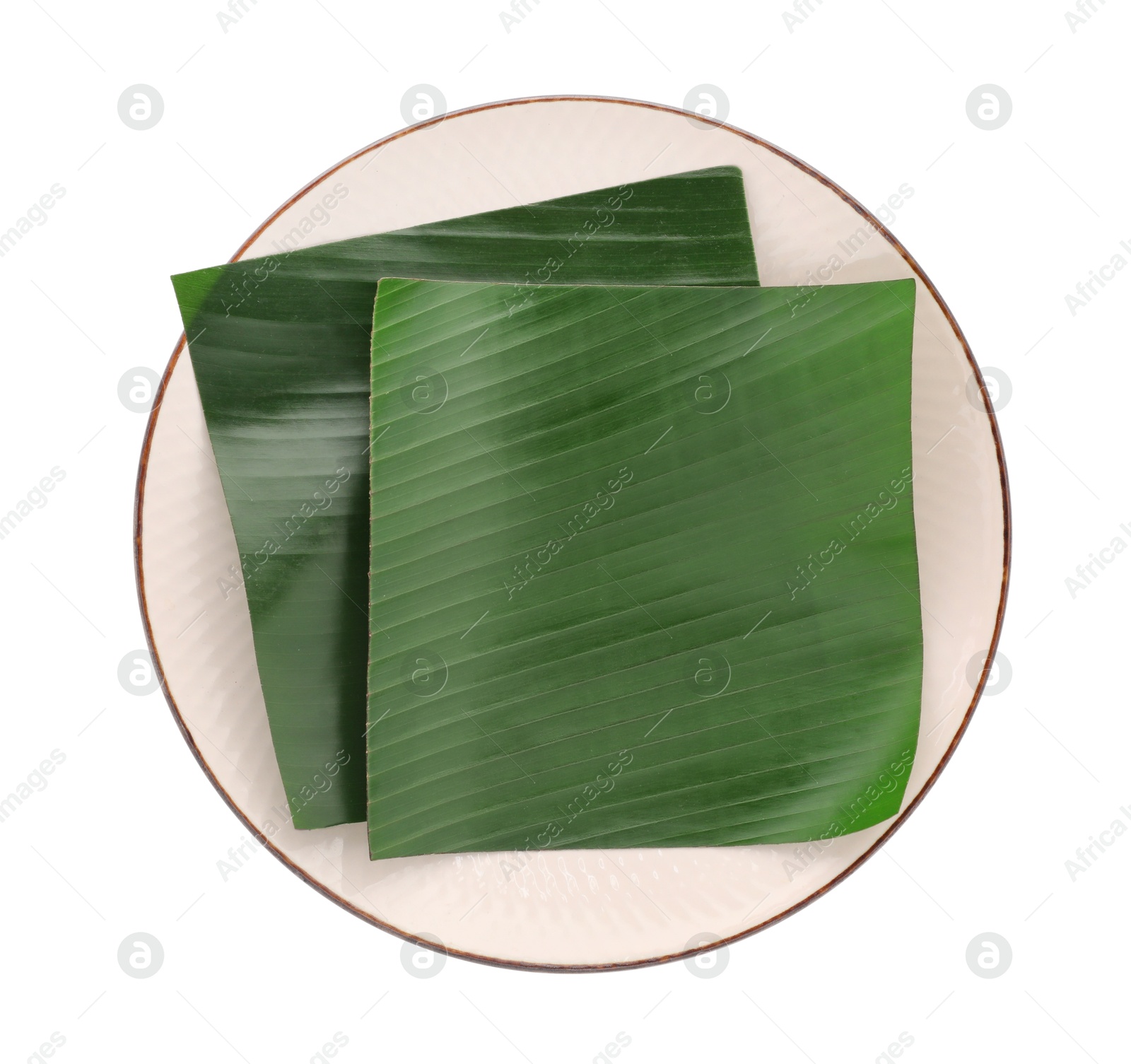 Photo of Pieces of banana leaves isolated on white, top view. Traditional meal serving