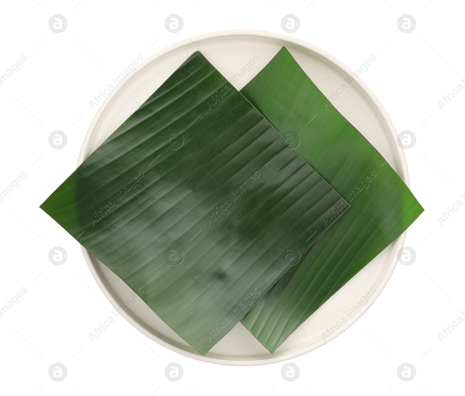 Photo of Pieces of banana leaves isolated on white, top view. Traditional meal serving