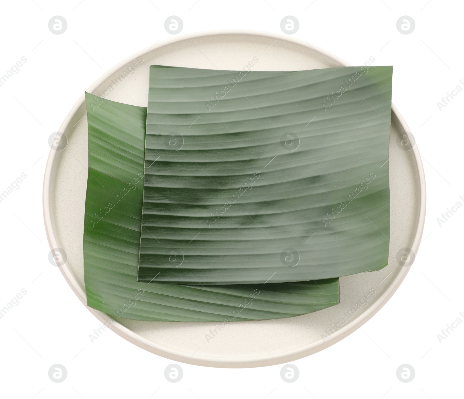 Photo of Pieces of banana leaves isolated on white. Traditional meal serving