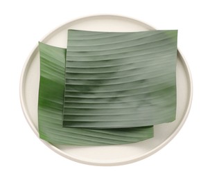 Photo of Pieces of banana leaves isolated on white. Traditional meal serving