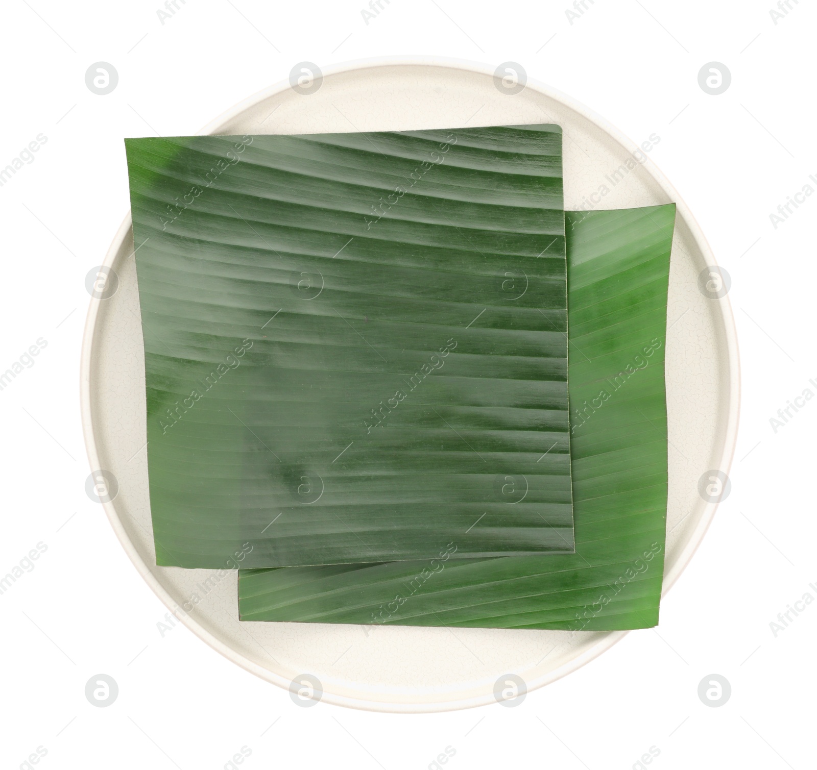 Photo of Pieces of banana leaves isolated on white, top view. Traditional meal serving