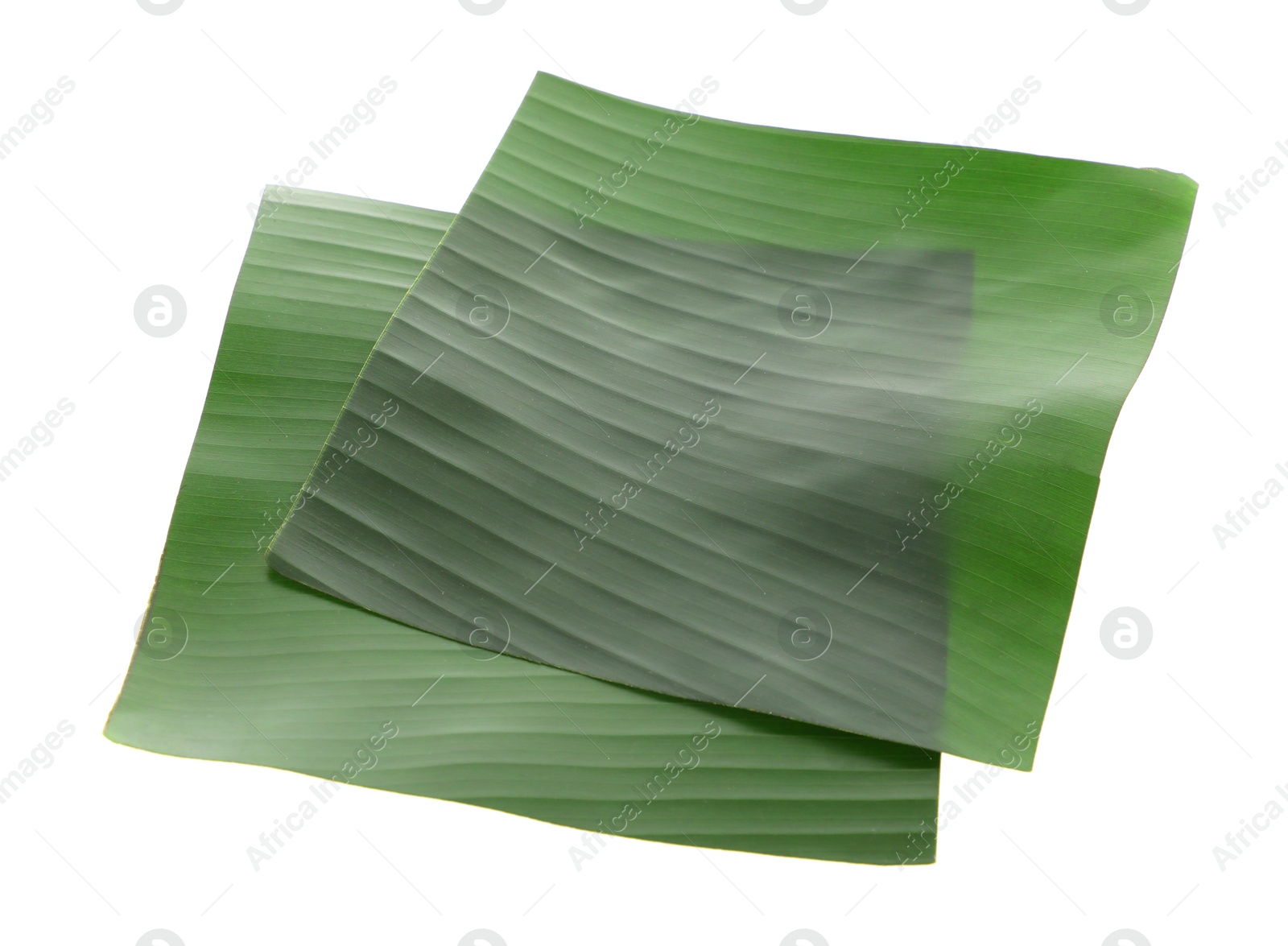 Photo of Pieces of banana leaves isolated on white. Traditional meal serving