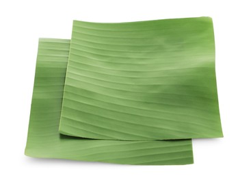 Photo of Pieces of banana leaves isolated on white. Traditional meal serving