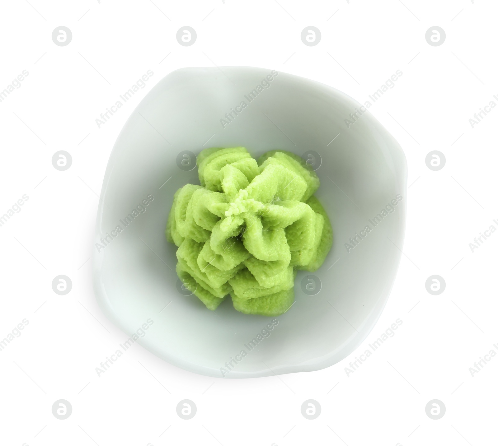 Photo of Hot wasabi paste in bowl isolated on white, top view