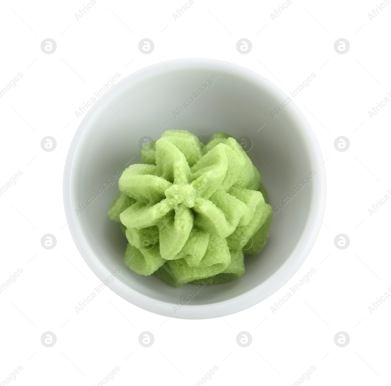 Photo of Hot wasabi paste in bowl isolated on white, top view