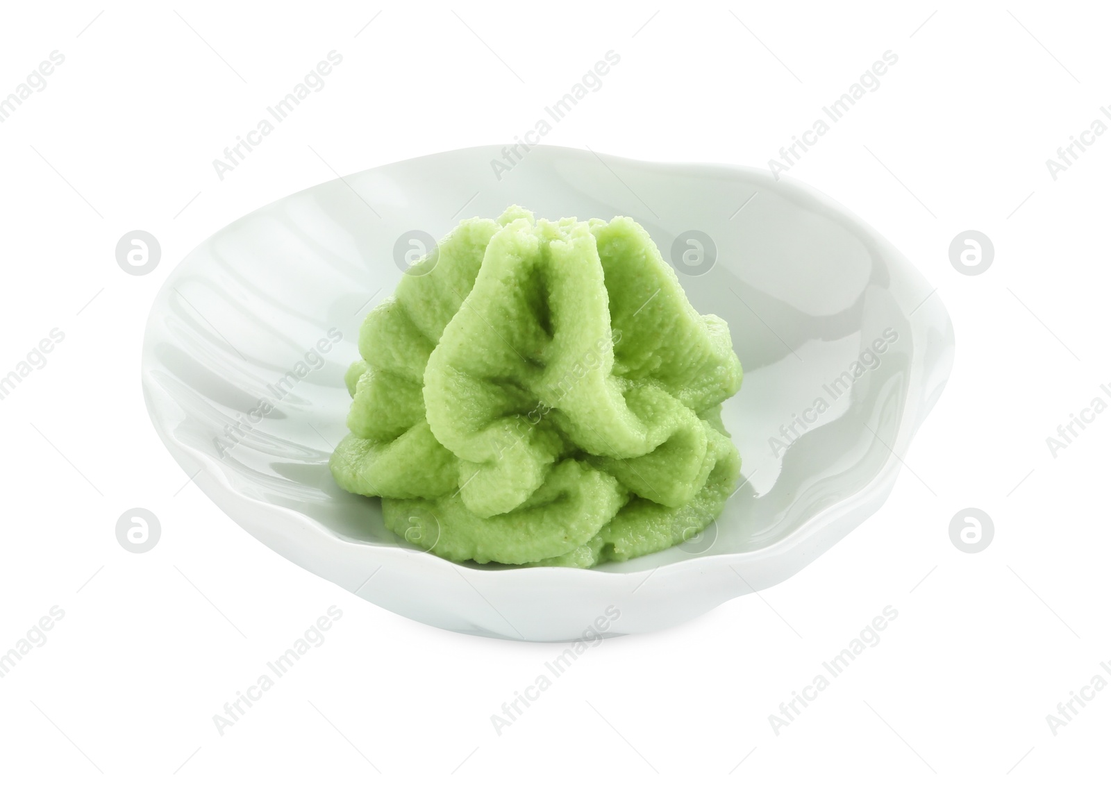 Photo of Hot wasabi paste in bowl isolated on white