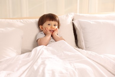 Photo of Cute little boy in bed at home