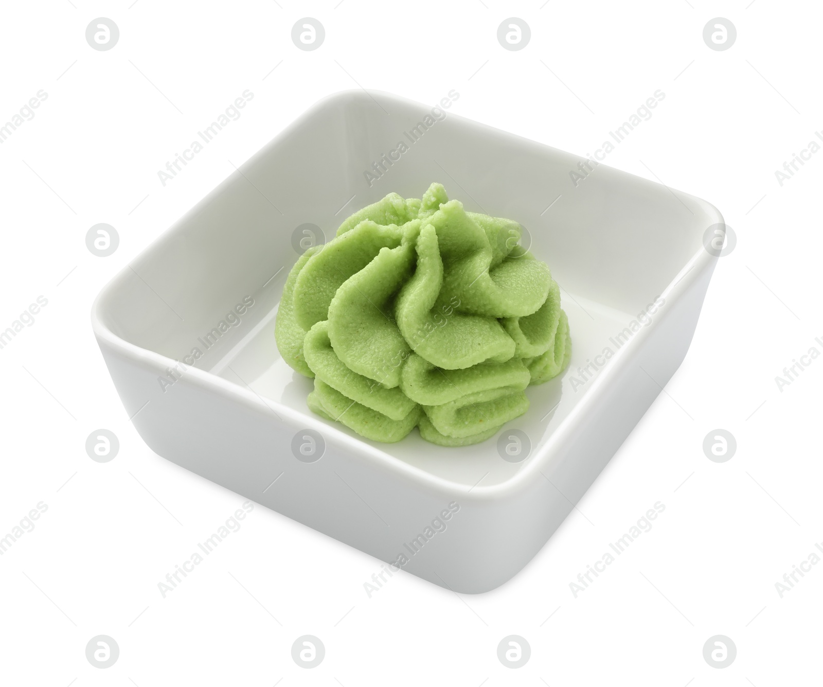 Photo of Hot wasabi paste in bowl isolated on white