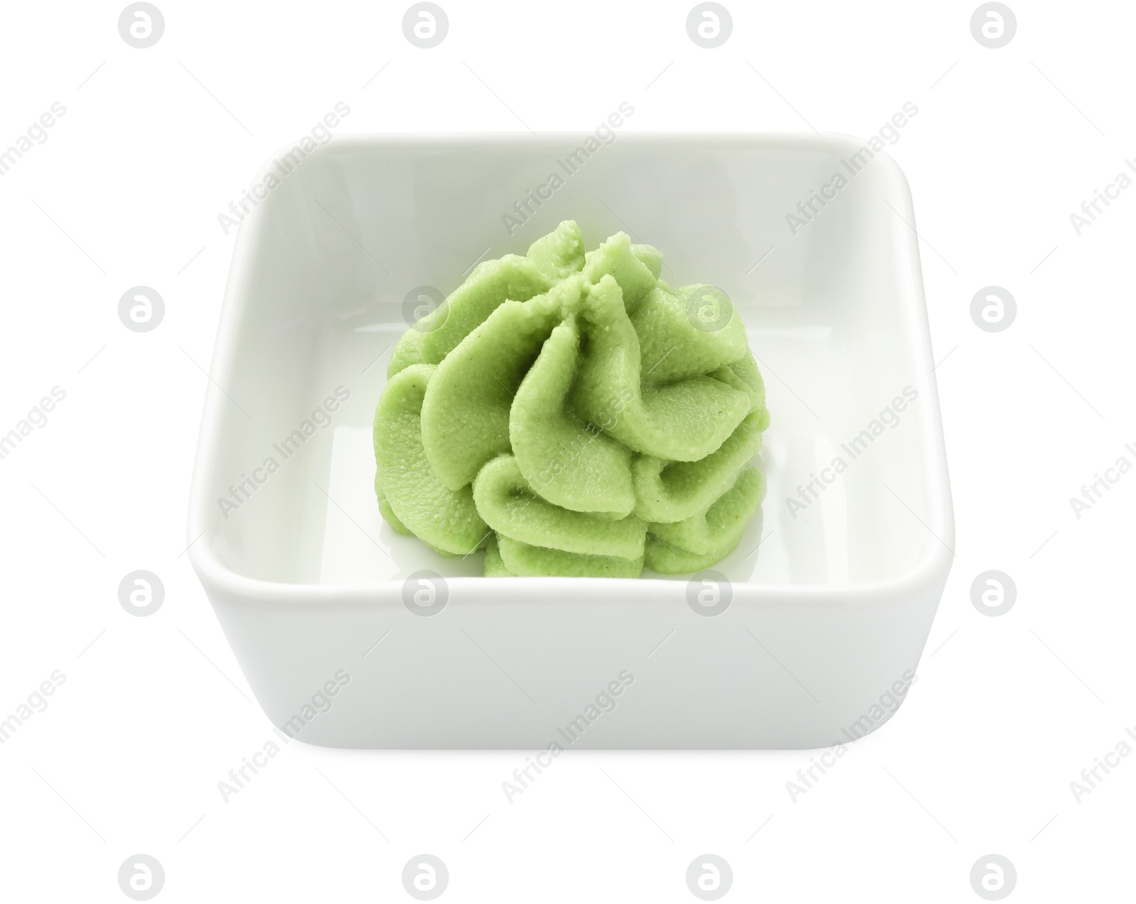 Photo of Hot wasabi paste in bowl isolated on white