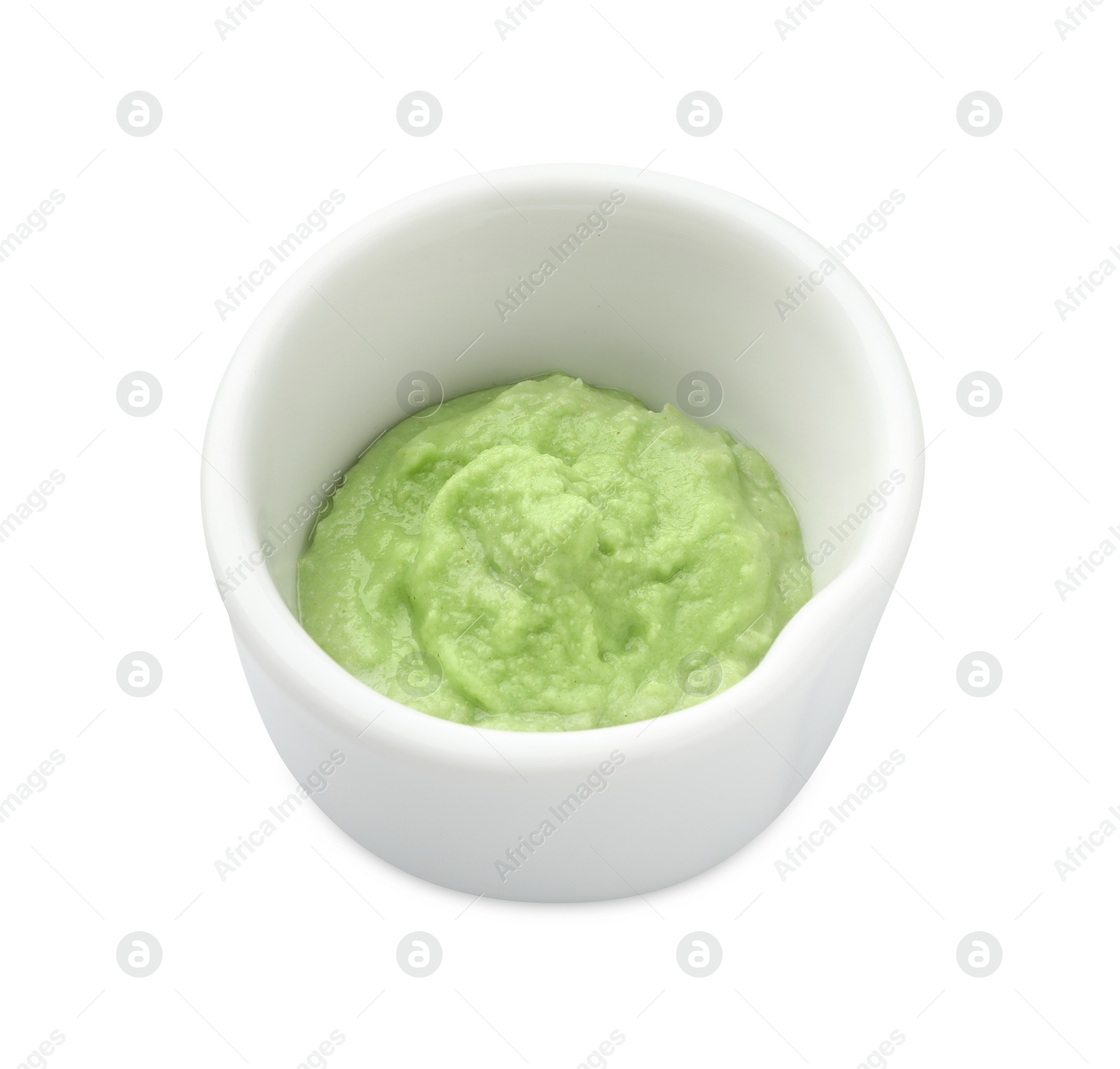 Photo of Hot wasabi paste in bowl isolated on white