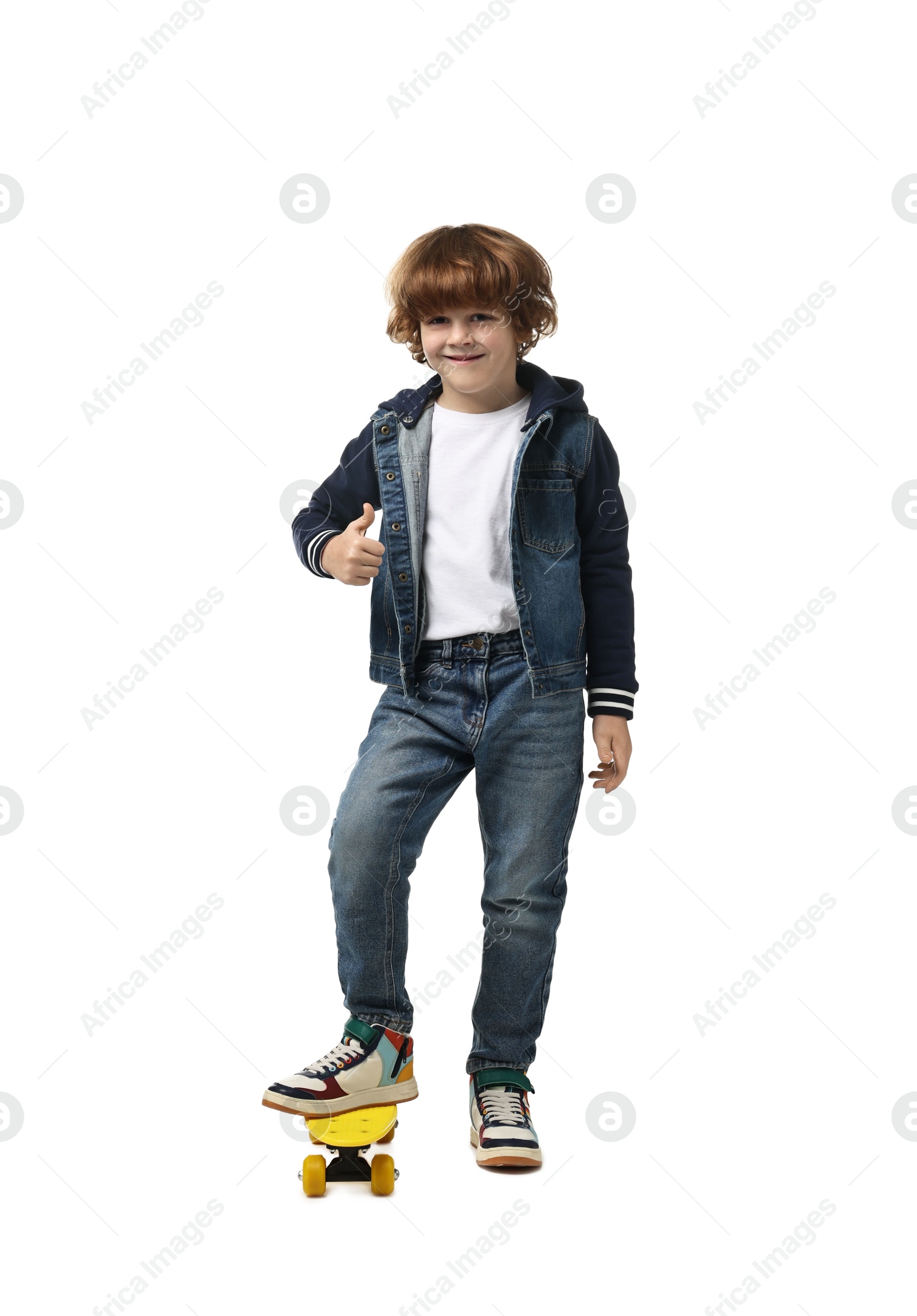 Photo of Little boy with penny board showing thumbs up on white background