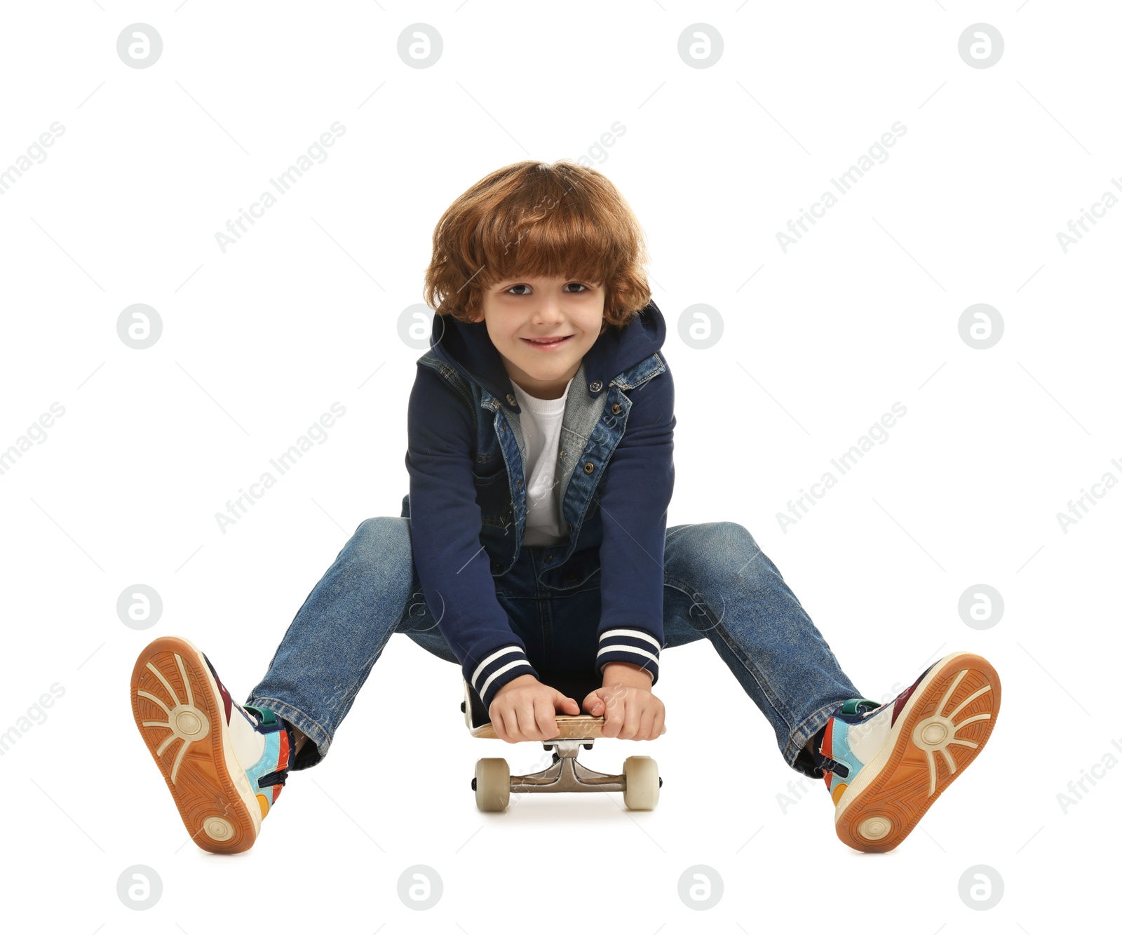 Photo of Little boy on skateboard against white background