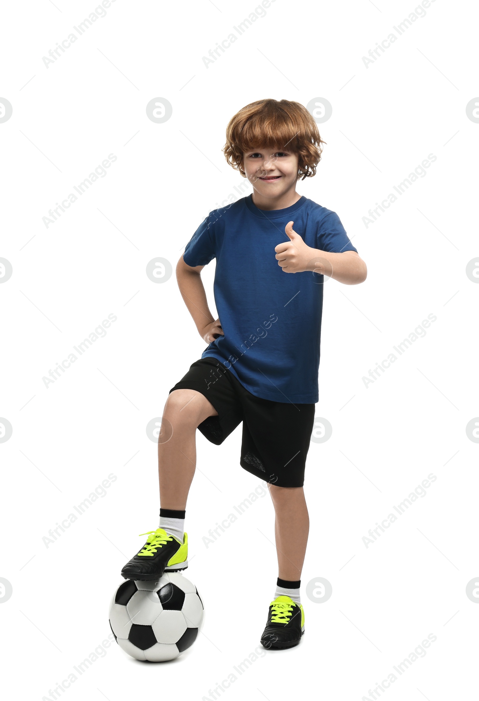 Photo of Little boy with soccer ball showing thumbs up on white background