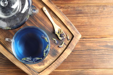 Photo of Delicious butterfly pea flower tea on wooden table, top view. Space for text