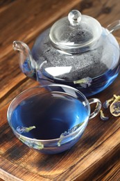 Photo of Delicious butterfly pea flower tea on wooden table, closeup