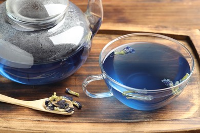 Photo of Delicious butterfly pea flower tea on wooden table, closeup