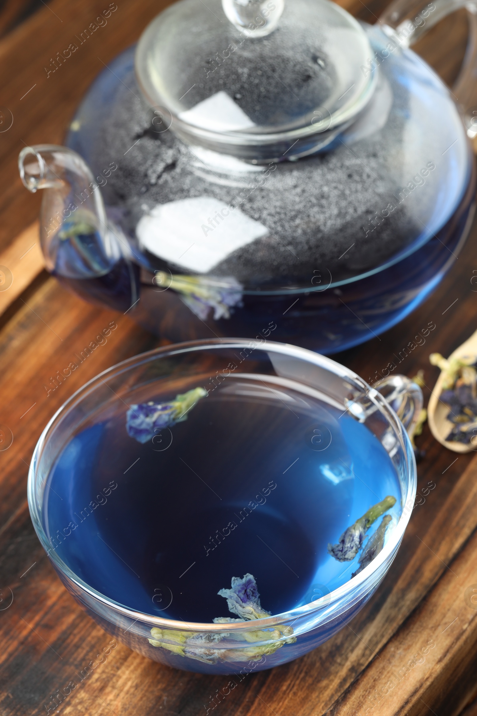 Photo of Delicious butterfly pea flower tea on wooden table, closeup