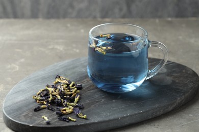 Photo of Delicious butterfly pea flower tea on gray textured table