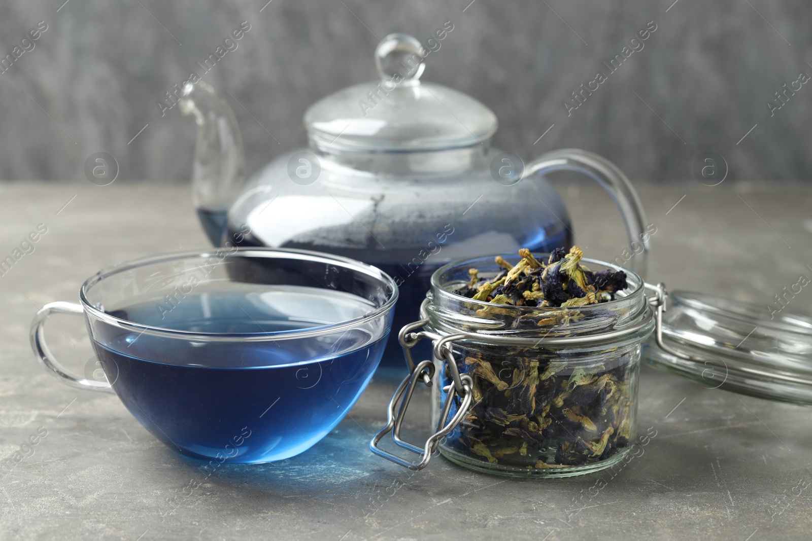 Photo of Delicious butterfly pea flower tea on gray textured table