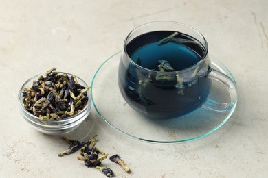 Photo of Delicious butterfly pea flower tea on gray textured table