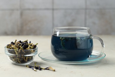 Photo of Delicious butterfly pea flower tea on gray textured table