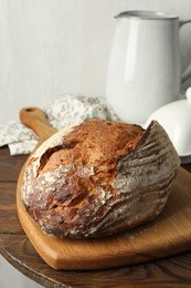 Photo of Freshly baked bread on wooden table, closeup