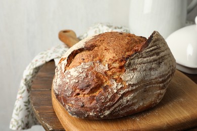 Photo of Freshly baked bread on wooden table, closeup