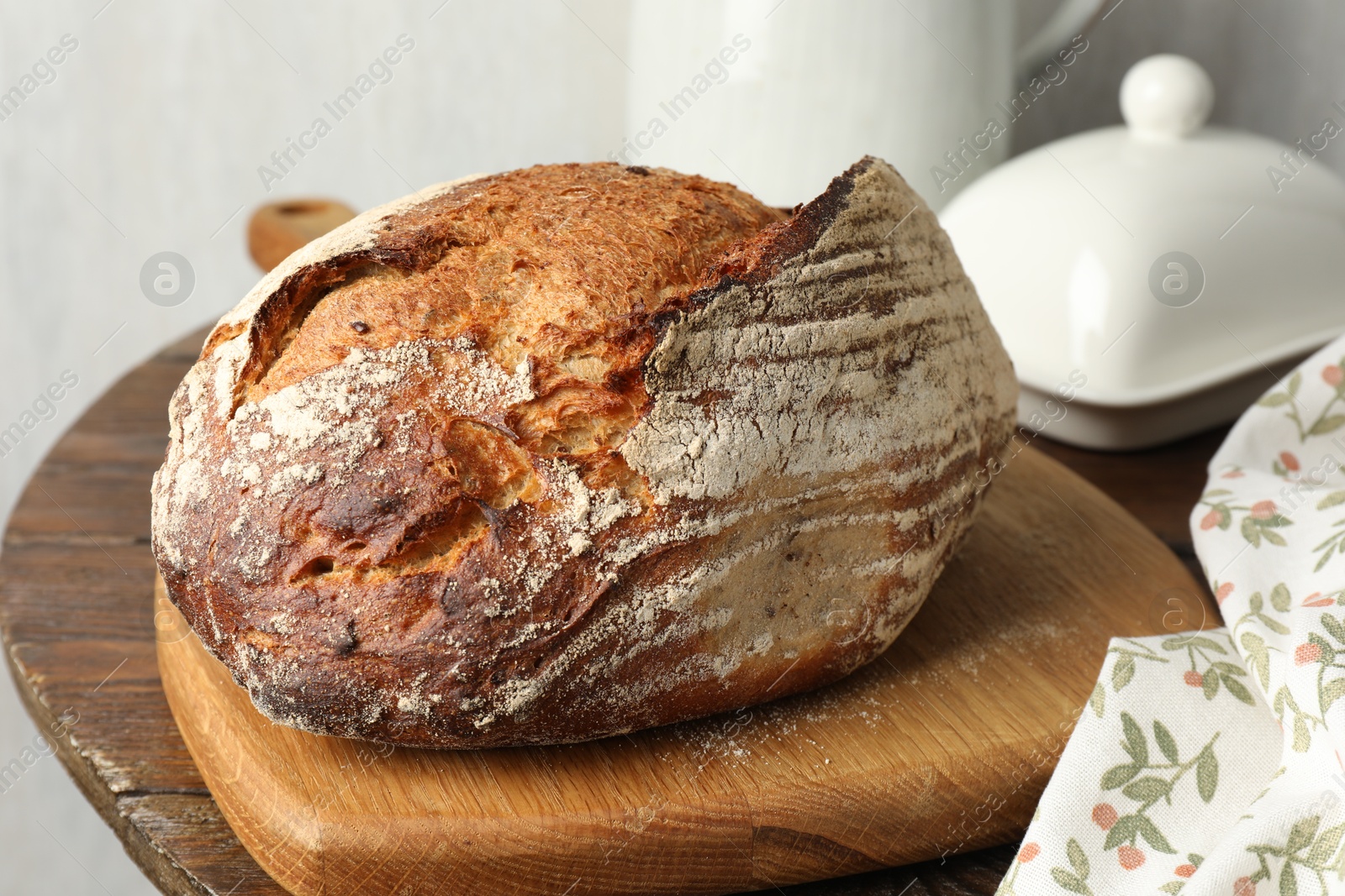 Photo of Freshly baked bread on wooden table, closeup