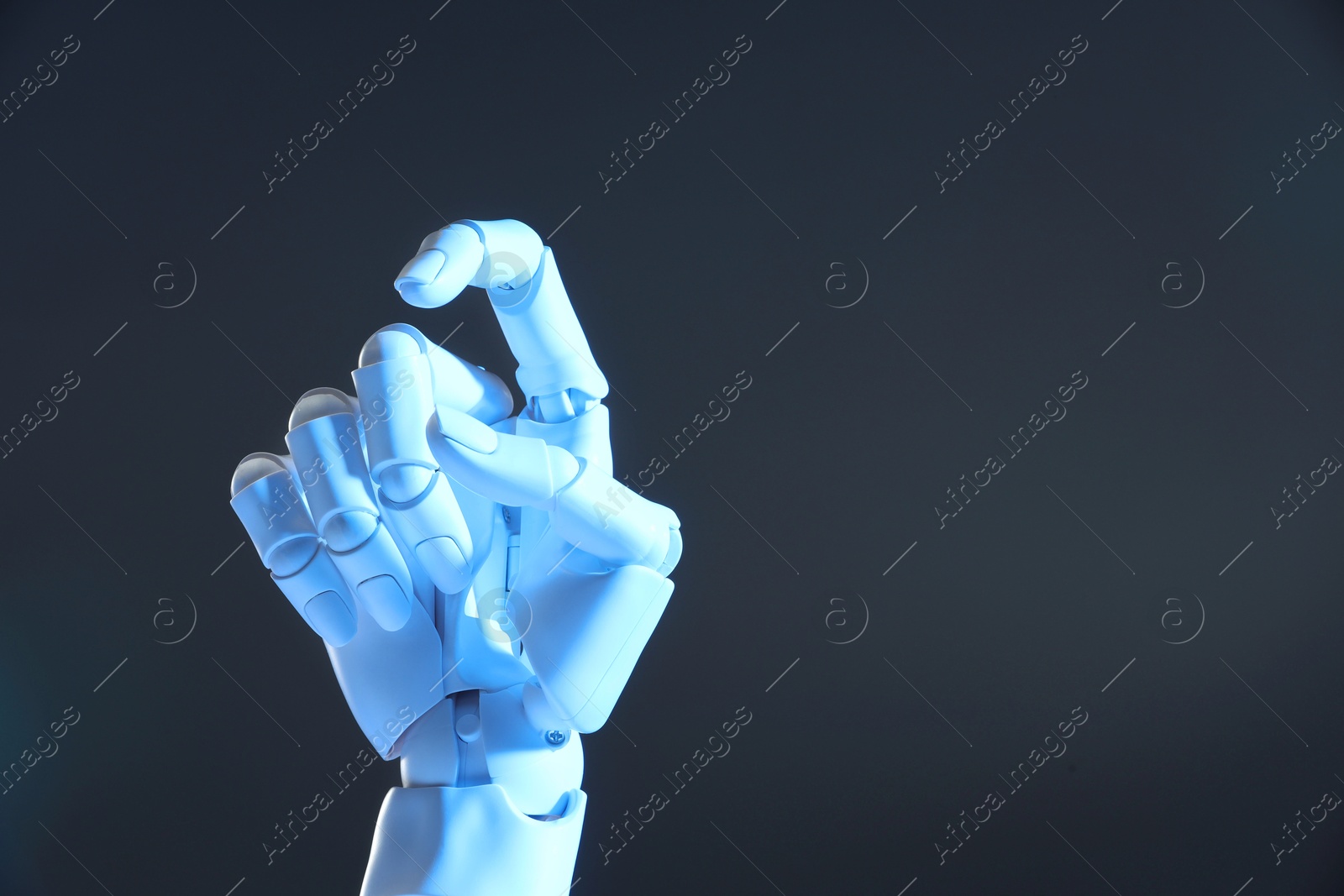 Photo of Artificial intelligence. Robot hand gesturing on grey background, space for text