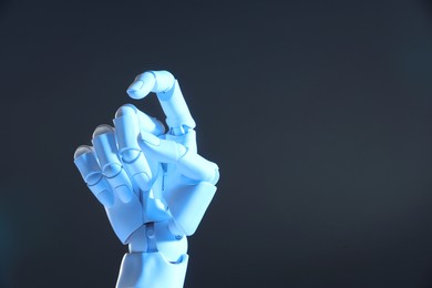 Photo of Artificial intelligence. Robot hand gesturing on grey background, space for text