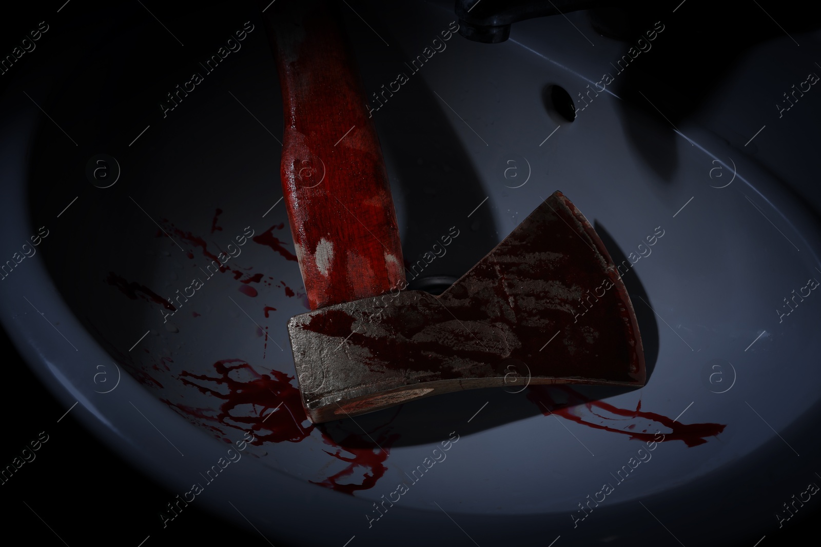 Image of Axe with blood in sink, above view