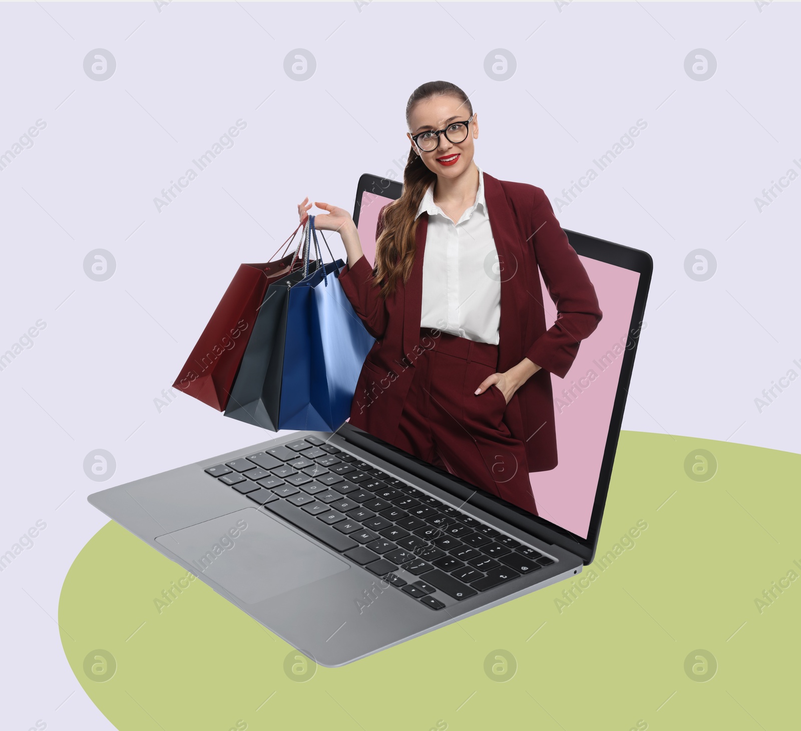 Image of Internet shopping. Happy woman with shopping bags coming out of laptop on color background