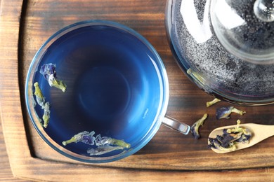 Photo of Delicious butterfly pea flower tea on wooden table, top view