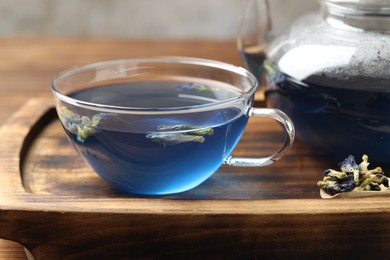 Photo of Delicious butterfly pea flower tea on wooden table, closeup