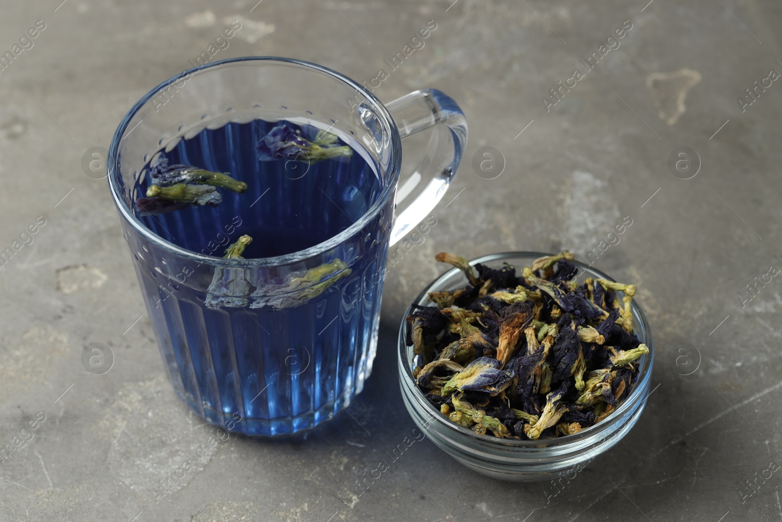 Photo of Delicious butterfly pea flower tea on gray textured table