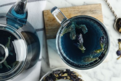 Photo of Delicious butterfly pea flower tea on light table, flat lay