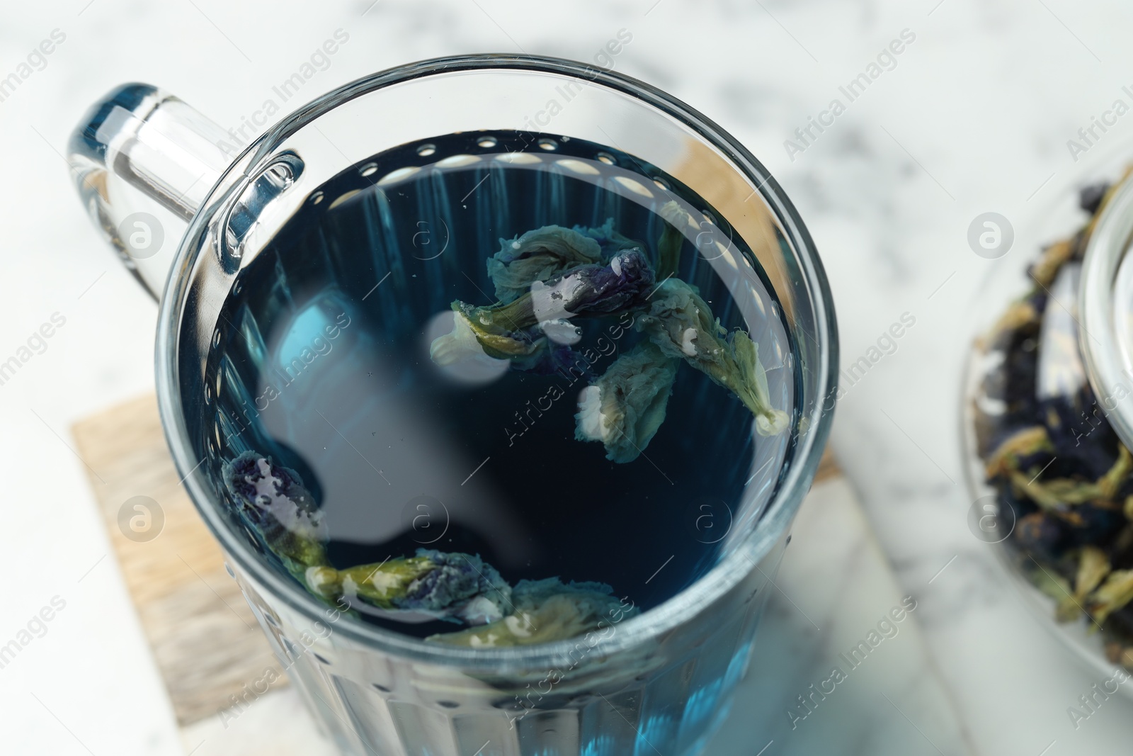 Photo of Delicious butterfly pea flower tea on light table, closeup