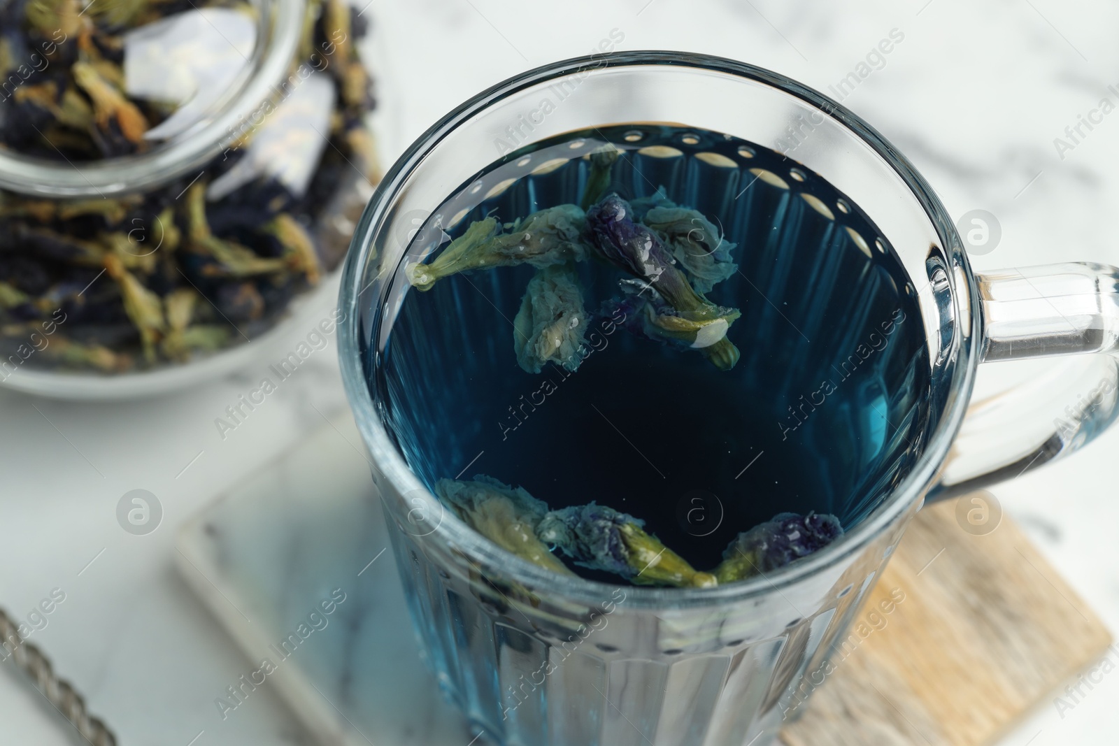 Photo of Delicious butterfly pea flower tea on light table, closeup