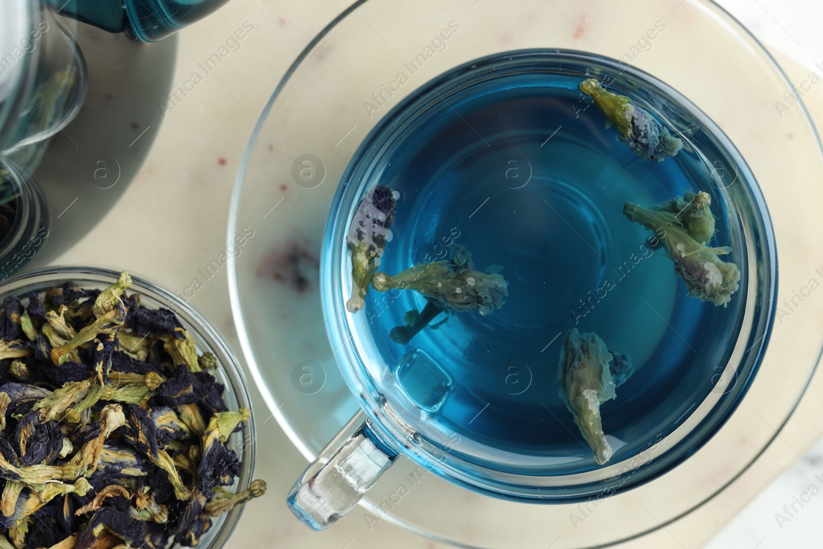 Photo of Delicious butterfly pea flower tea on light table, flat lay