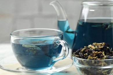 Photo of Delicious butterfly pea flower tea on light table, closeup