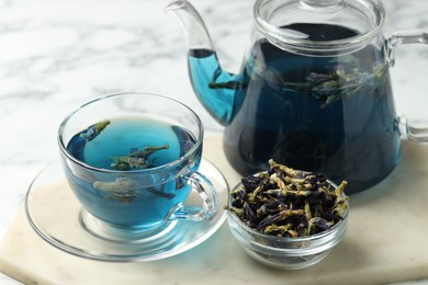 Photo of Delicious butterfly pea flower tea on light table, closeup