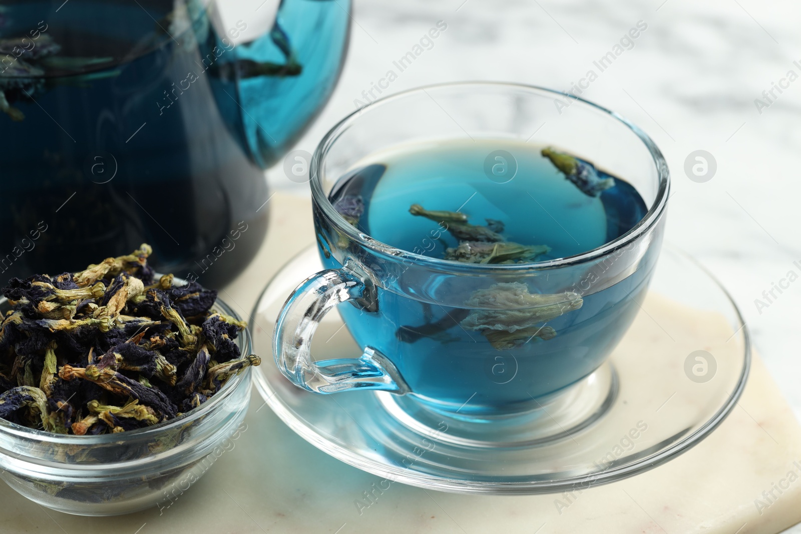 Photo of Delicious butterfly pea flower tea on light table, closeup