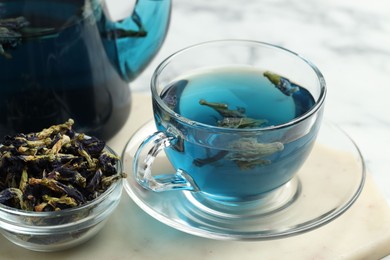 Photo of Delicious butterfly pea flower tea on light table, closeup