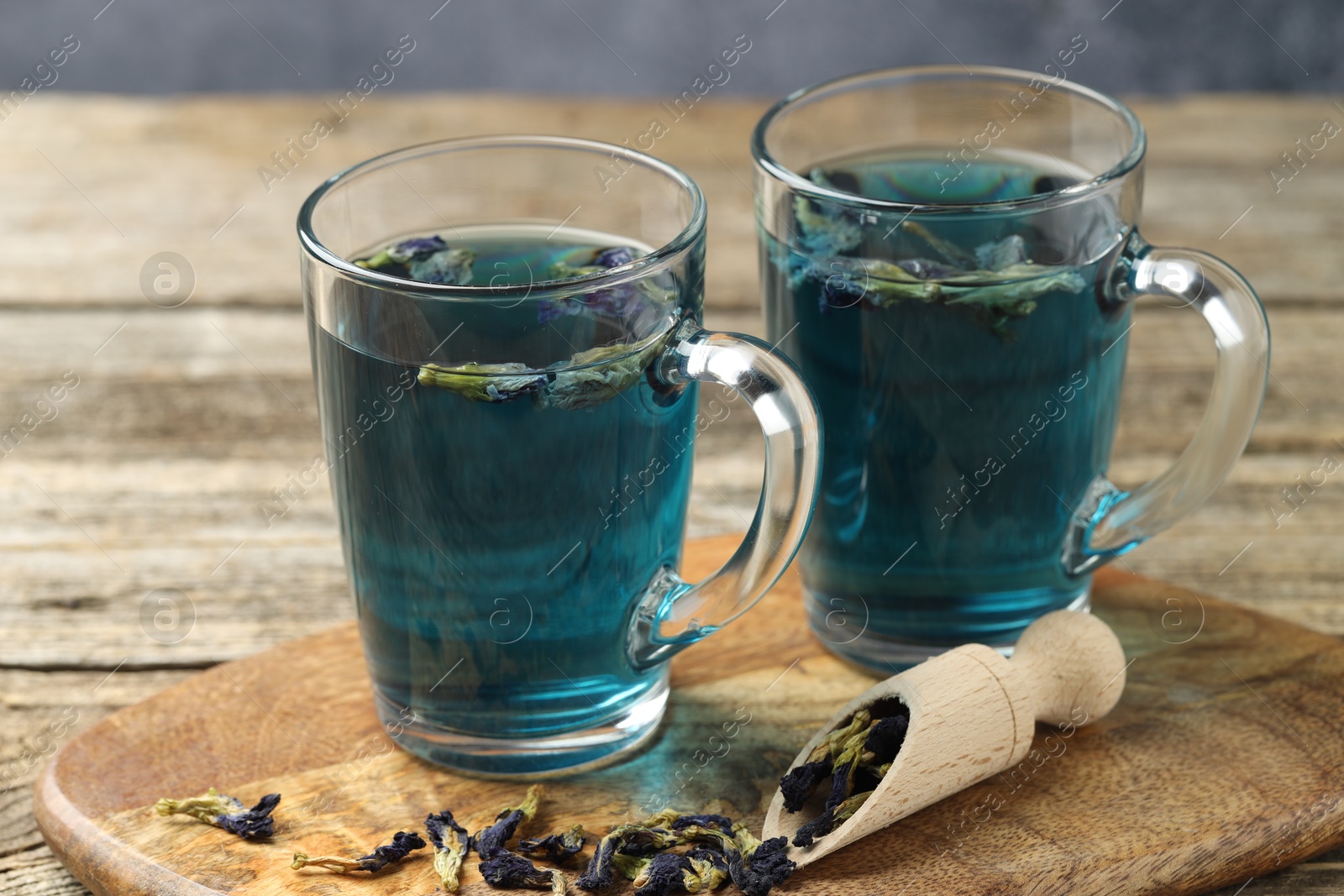 Photo of Delicious butterfly pea flower tea on wooden table