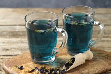 Photo of Delicious butterfly pea flower tea on wooden table